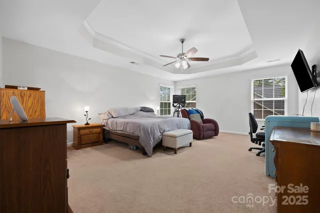 a spacious bedroom with a bed and furniture