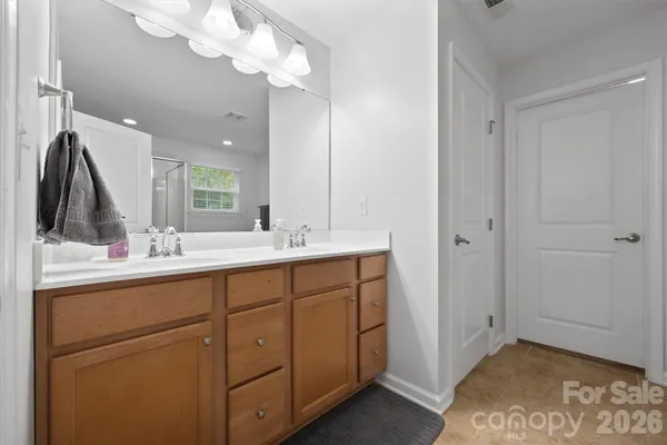 a bathroom with a double vanity sink and a mirror