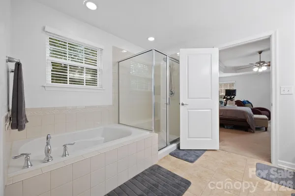 a en suite spacious bathroom with a tub and a shower