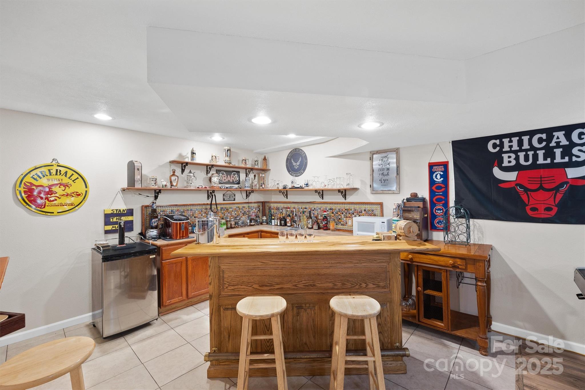 4237 Little Fork Cove Road Denver, NC 28037 - Photo 31 of 38 a kitchen with stainless steel appliances granite countertop a stove top oven a sink a dining table and chairs with wooden floor