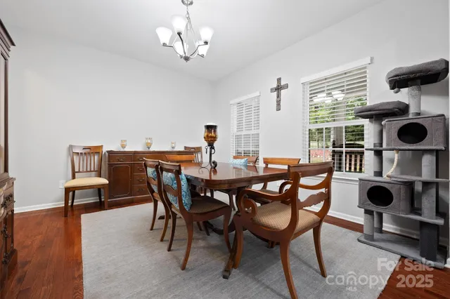 a view of a dining room with furniture and chandelier