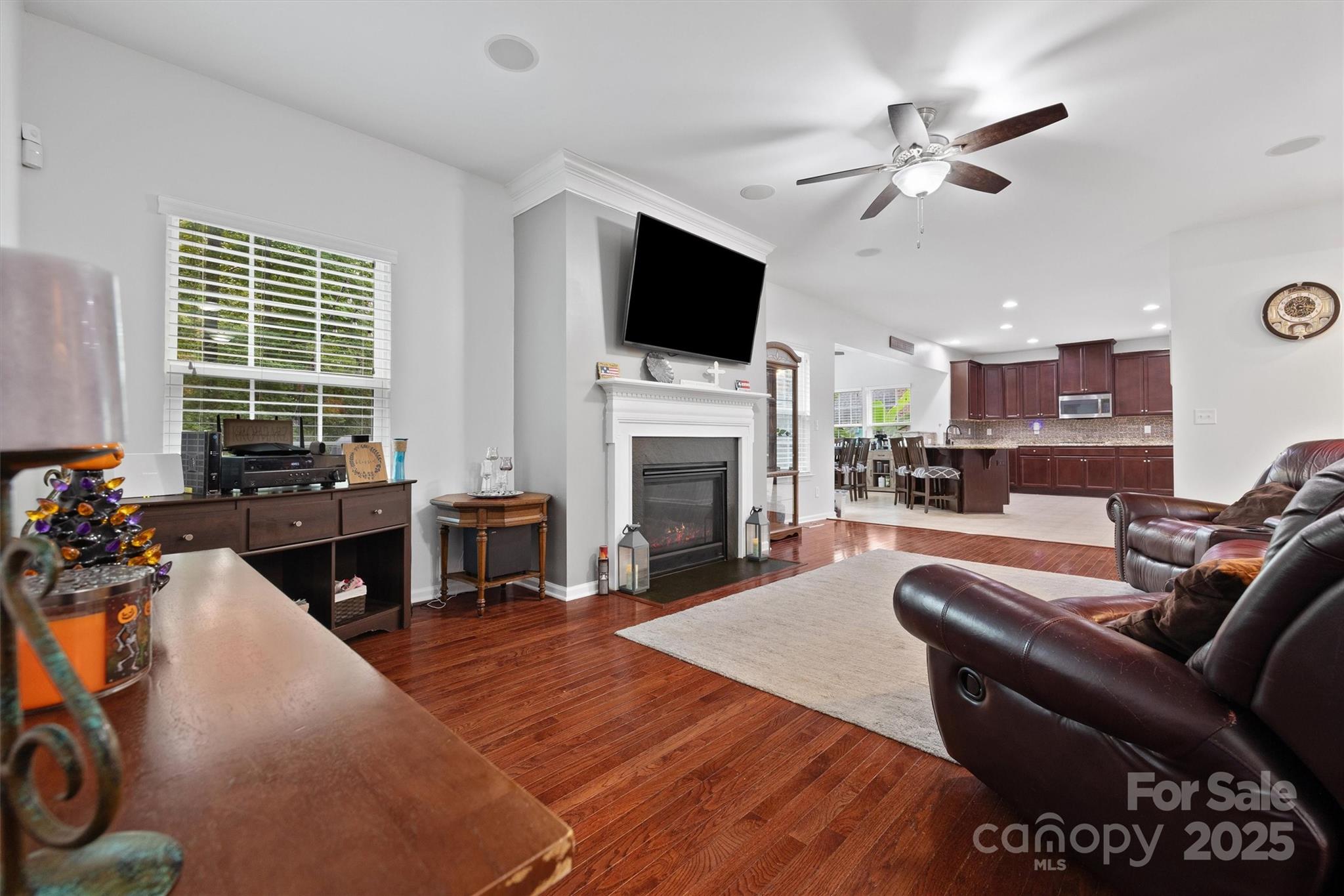 4237 Little Fork Cove Road Denver, NC 28037 - Photo 7 of 38 a living room with furniture a fireplace and a flat screen tv