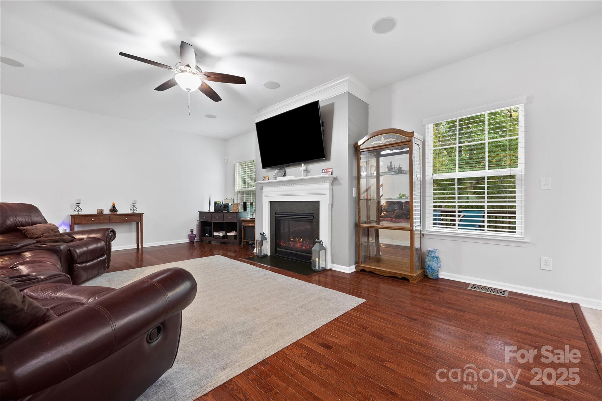 4237 Little Fork Cove Road Denver, NC 28037 - Photo 8 of 38 a living room with furniture a flat screen tv and a fireplace
