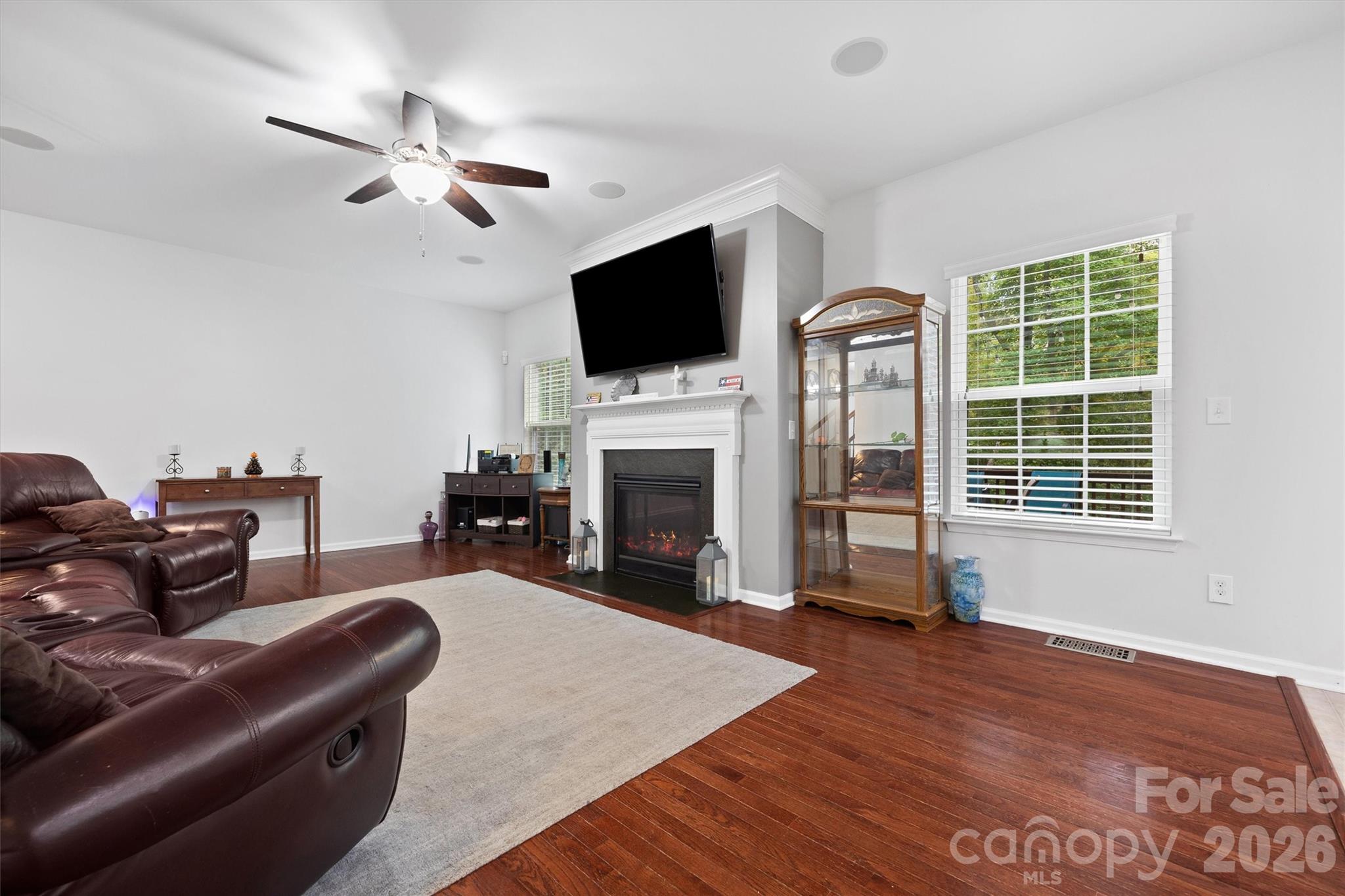 4237 Little Fork Cove Road Denver, NC 28037 - Photo 9 of 40 a living room with furniture a flat screen tv and a fireplace