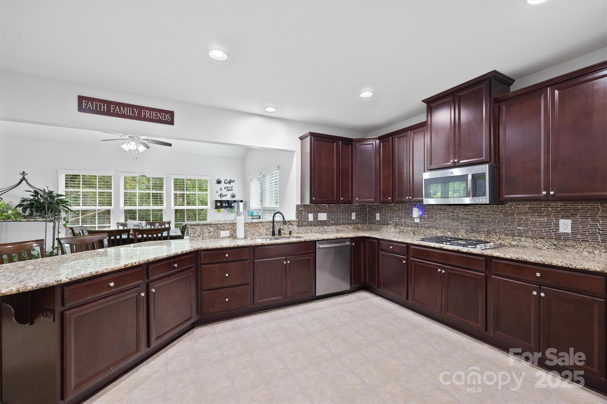 4237 Little Fork Cove Road Denver, NC 28037 - Photo 10 of 38 a large kitchen with wooden cabinets and sink