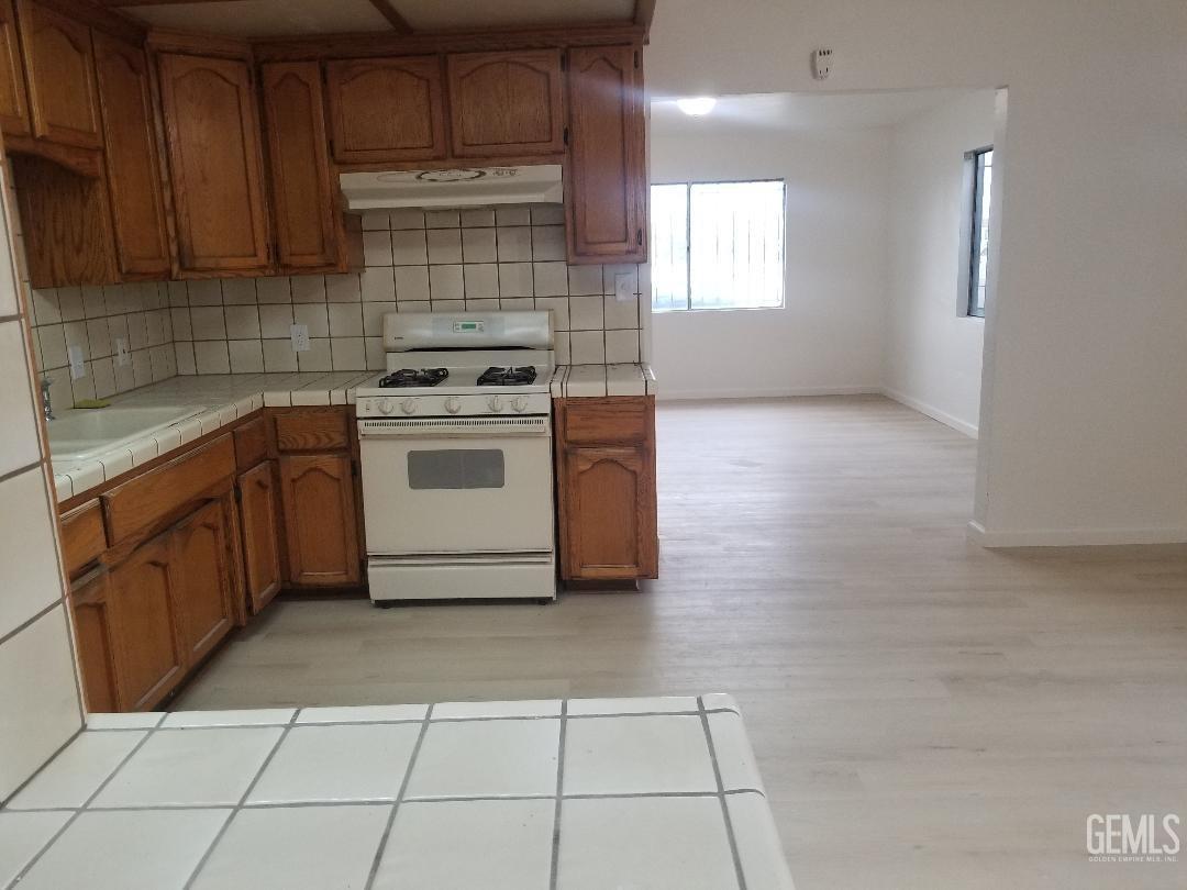 Undisclosed Address Delano, CA 93215 - Photo 3 of 8 a kitchen with a cabinets and a stove top oven