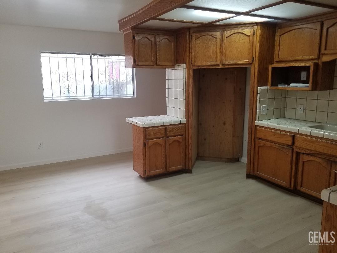 Undisclosed Address Delano, CA 93215 - Photo 4 of 8 a kitchen with cabinets and window