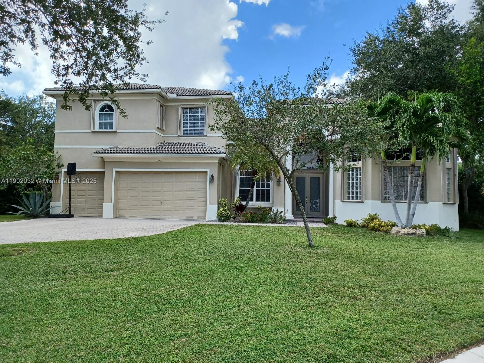a front view of a house with a yard and garage