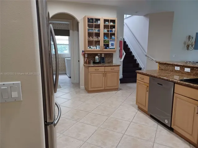 a kitchen with a sink and a stove top oven