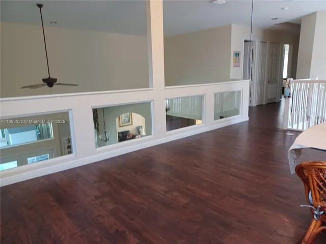a view of an entryway with wooden floor