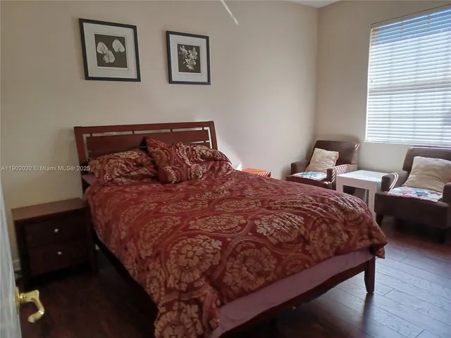 a bed sitting in a bedroom next to a window