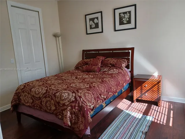 a large bed sitting in a bedroom next to a window