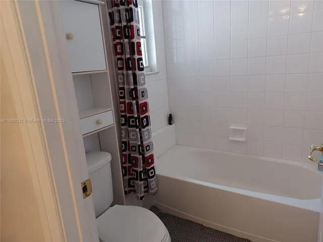 a bathroom with a toilet and a bathtub