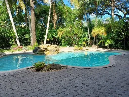 a view of a swimming pool with a yard