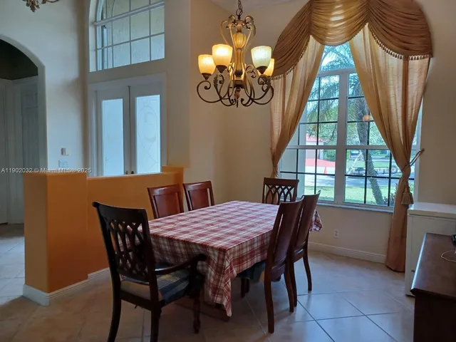 a view of a dining room with furniture and a large window