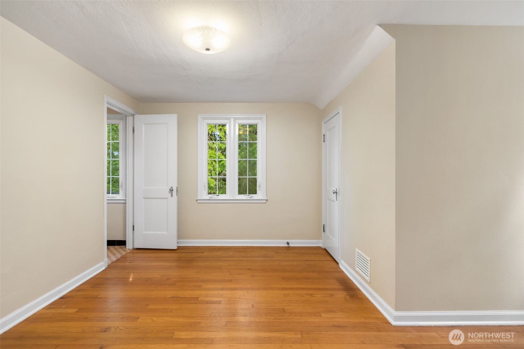 9520 Dishman Road Northwest Bremerton, WA 98312 - Photo 17 of 38 an empty room with wooden floor and windows