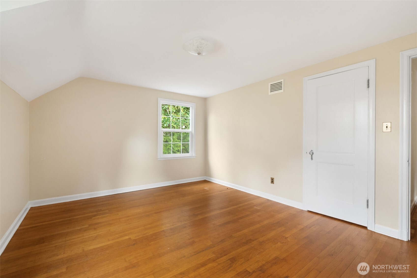 9520 Dishman Road Northwest Bremerton, WA 98312 - Photo 21 of 38 a view of an empty room with wooden floor and a window