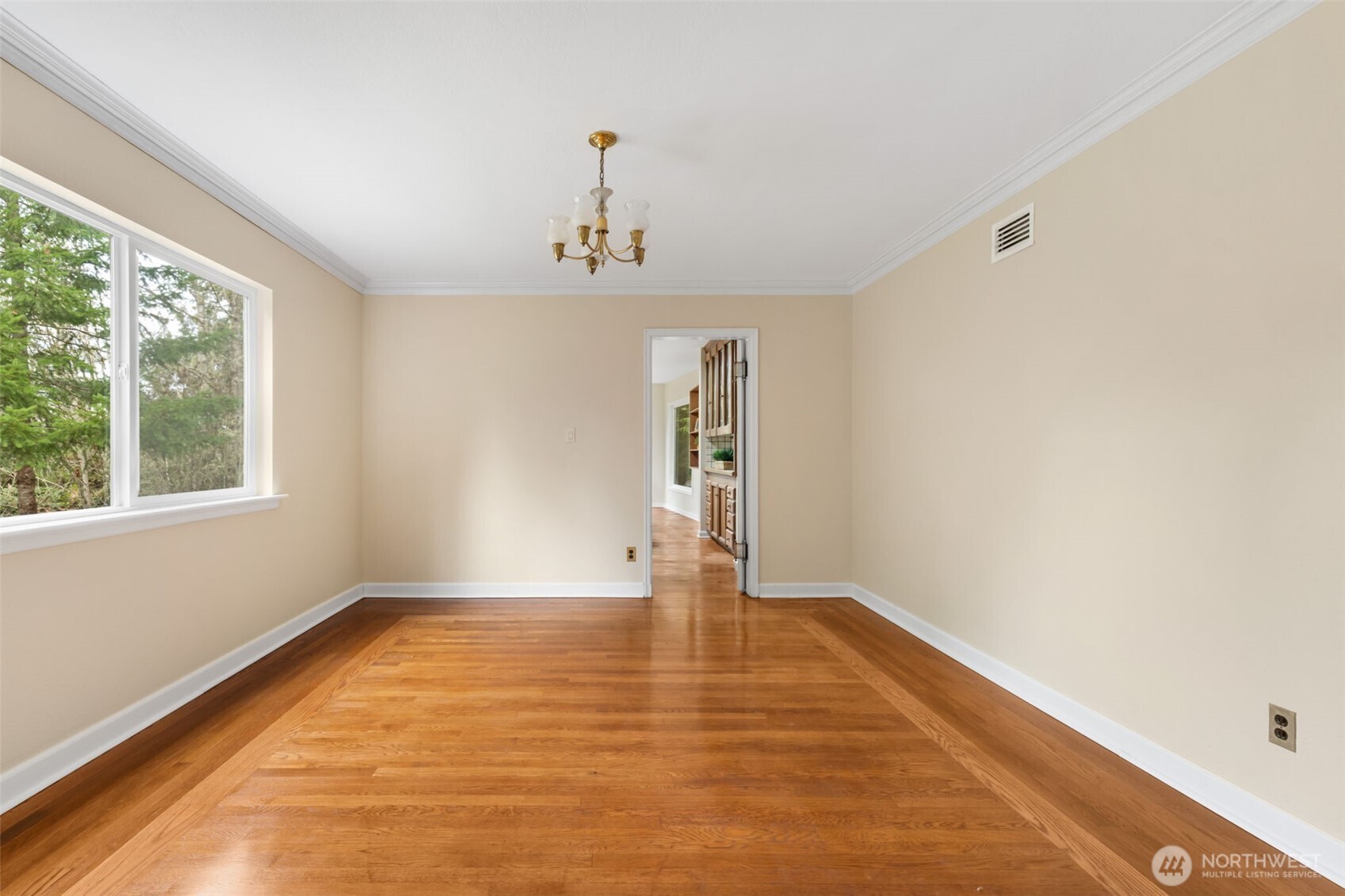 9520 Dishman Road Northwest Bremerton, WA 98312 - Photo 8 of 38 a view of an empty room with wooden floor and a window