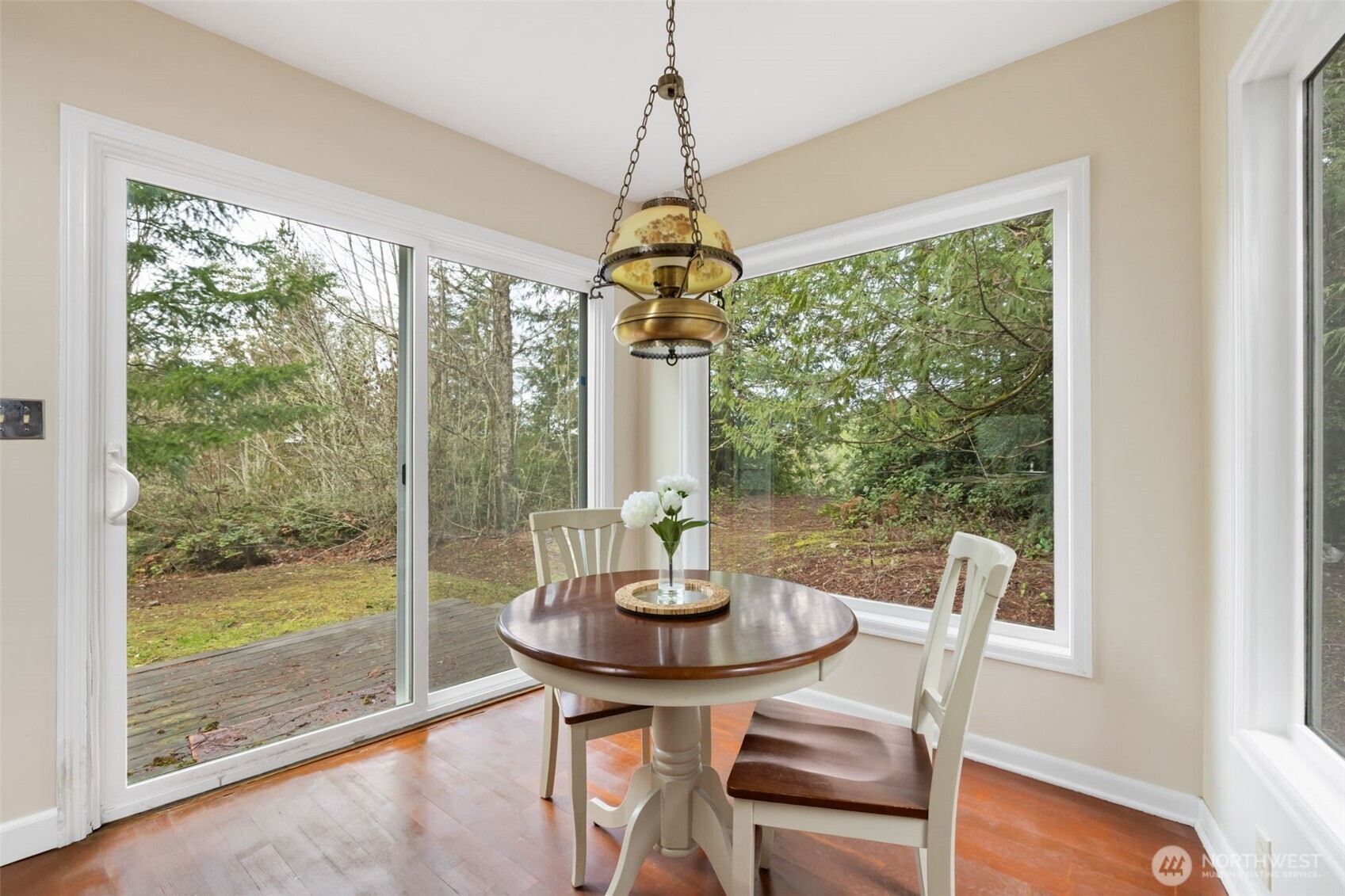 9520 Dishman Road Northwest Bremerton, WA 98312 - Photo 10 of 38 a dining room with a glass table and a floor to ceiling window