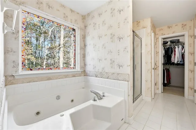 a bathroom with a tub and a shower