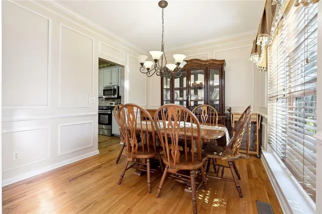 a view of a dining room with furniture window and wooden floor