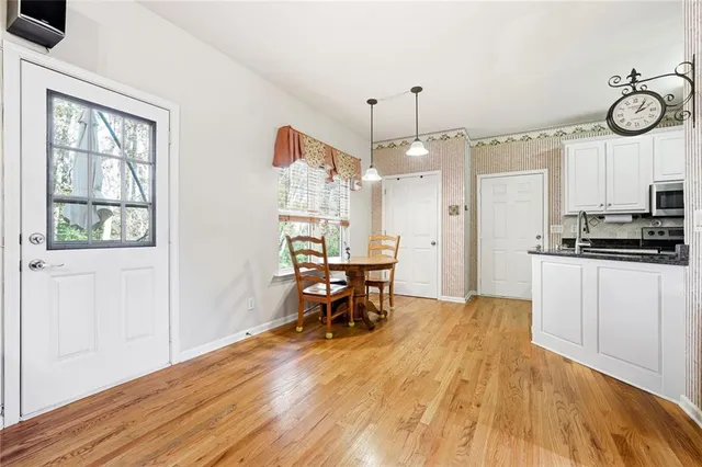 a view of a dining room with furniture window and wooden floor