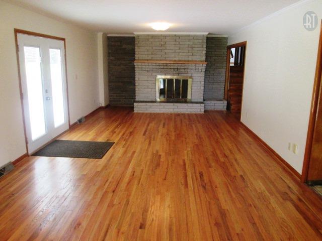 599 Cortner Road Normandy, TN 37360 - Photo 3 of 21 an empty room with wooden floor and fireplace