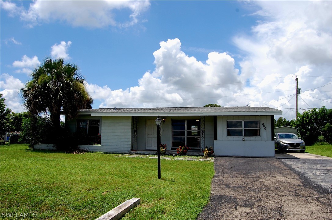 200 Oregon Road West Lehigh Acres, FL 33936 - Photo 1 of 18 a house view with a garden space