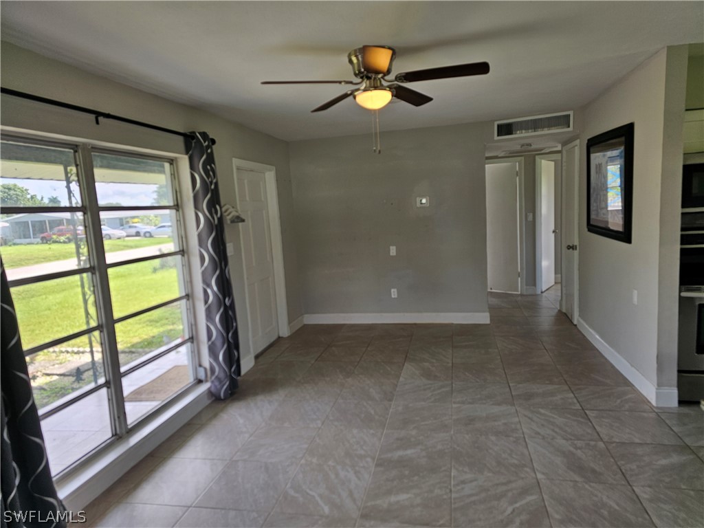 200 Oregon Road West Lehigh Acres, FL 33936 - Photo 11 of 18 a view of an empty room with a window
