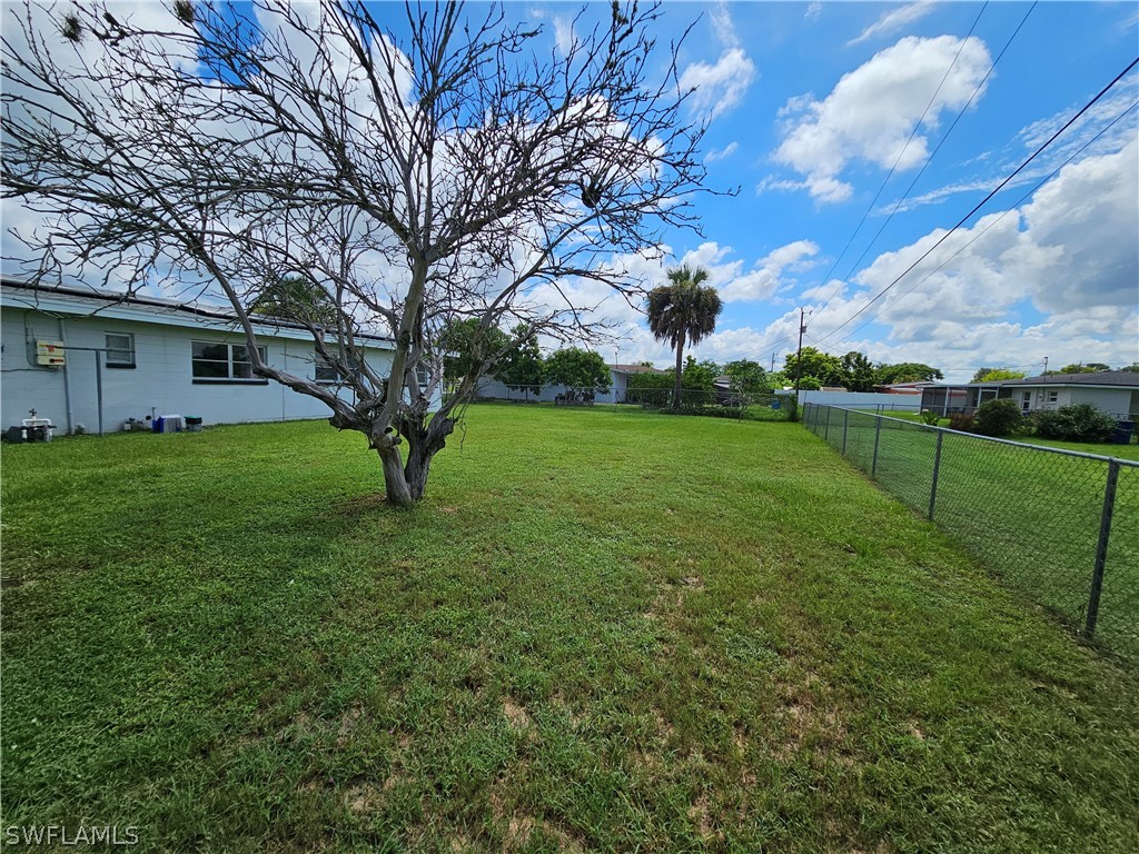 200 Oregon Road West Lehigh Acres, FL 33936 - Photo 16 of 18 a view of a yard with a large tree