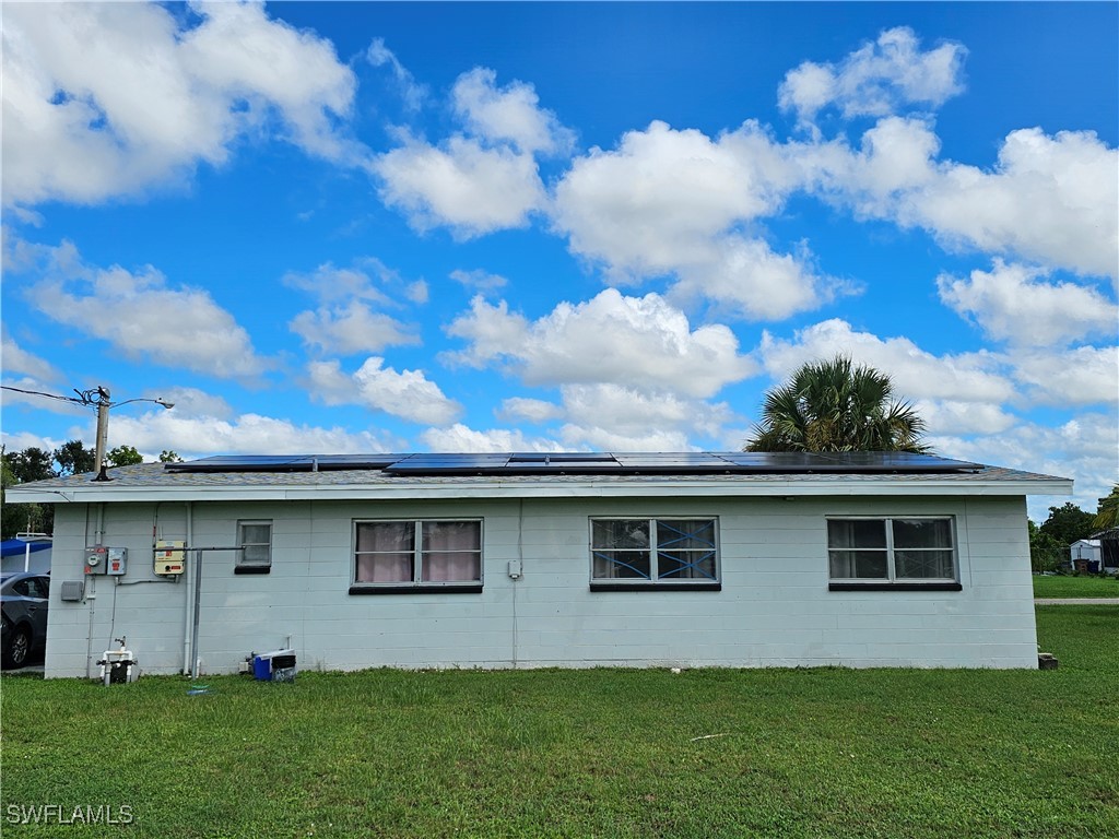200 Oregon Road West Lehigh Acres, FL 33936 - Photo 18 of 18 a view of a yard with a house in the background