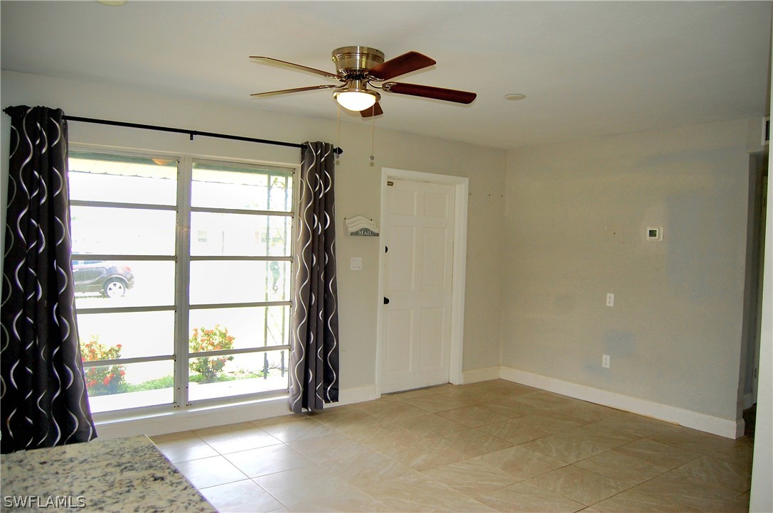 200 Oregon Road West Lehigh Acres, FL 33936 - Photo 2 of 18 wooden floor in an empty room with a window