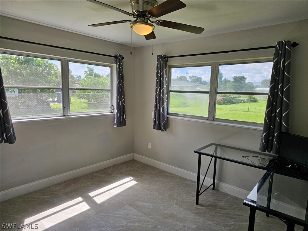 200 Oregon Road West Lehigh Acres, FL 33936 - Photo 6 of 18 a view of an empty room with a window