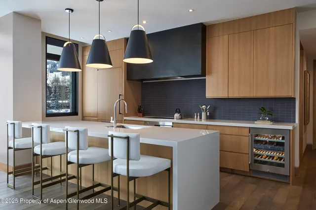 a kitchen with stainless steel appliances granite countertop a sink a stove and a refrigerator