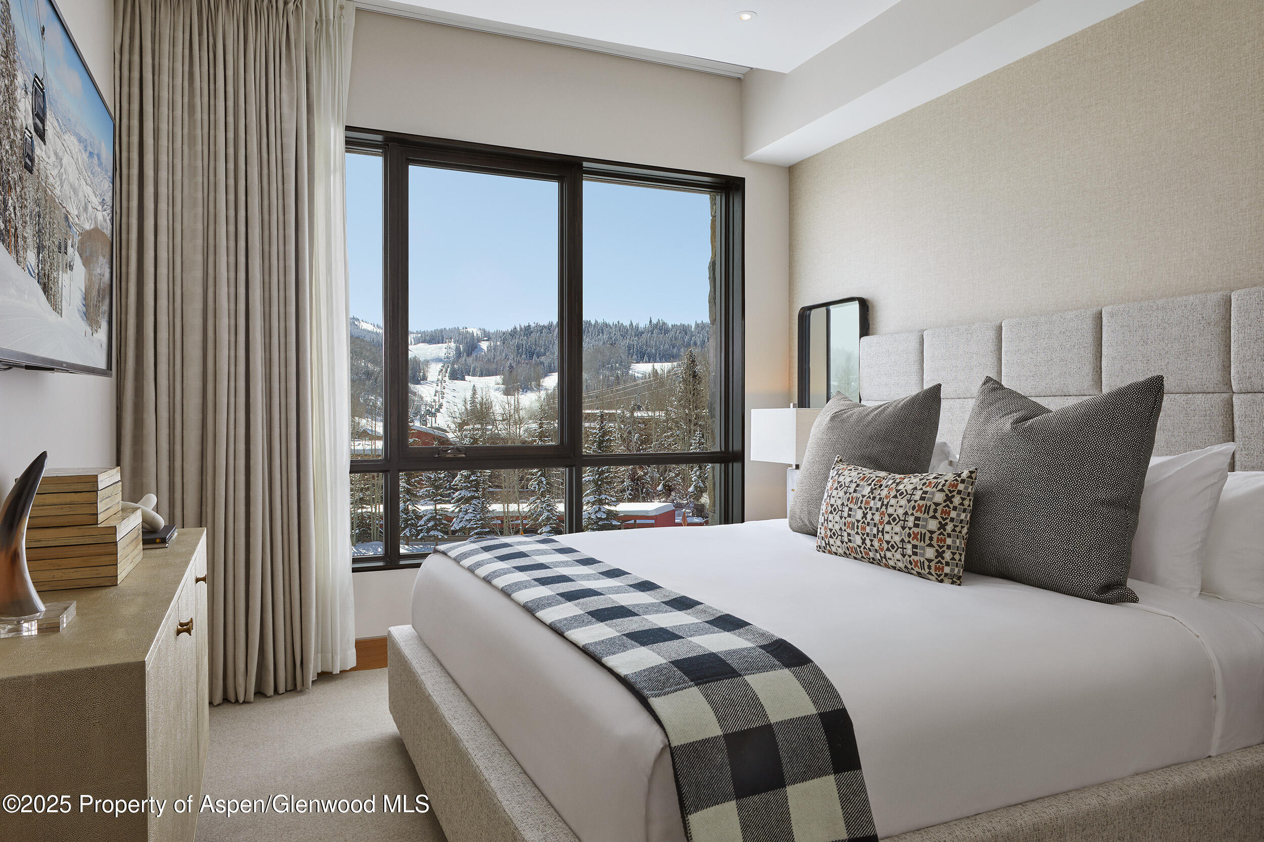 77 Wood Road, Unit 30610 Snowmass Village, CO 81615 - Photo 3 of 6 a bedroom with a balcony a bed and a large window