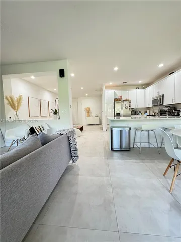 a view of a livingroom with furniture and a flat screen tv