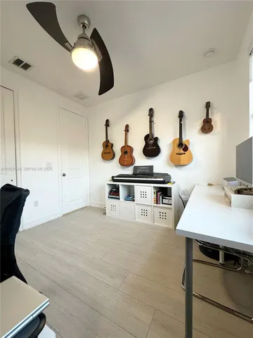 a view of house with outdoor seating and plants