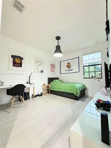 a view of a swimming pool with chairs and a table