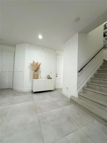 a large kitchen with cabinets stainless steel appliances and a counter space