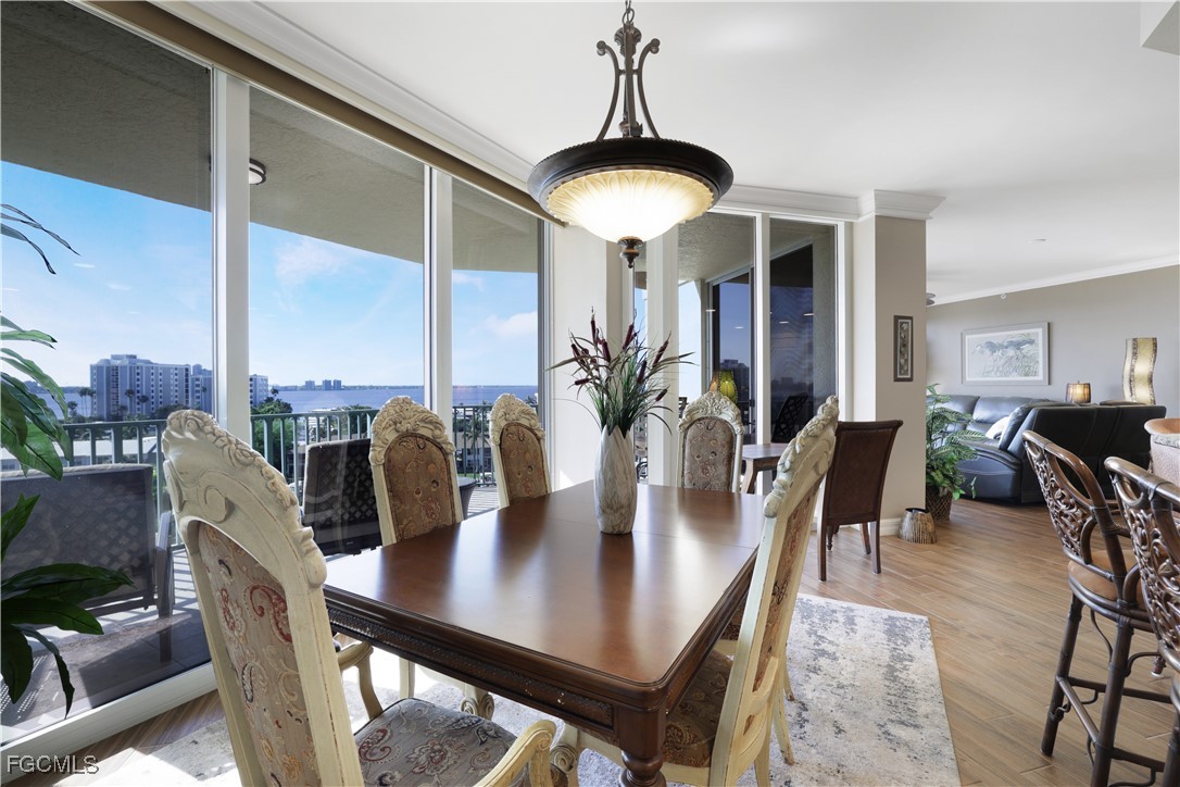 3426 Hancock Bridge Parkway, Unit 704 North Fort Myers, FL 33903 - Photo 12 of 37 a view of a dining room with furniture window and wooden floor