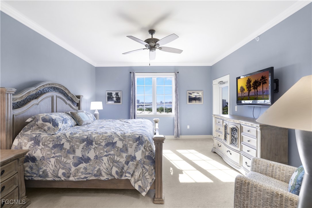 3426 Hancock Bridge Parkway, Unit 704 North Fort Myers, FL 33903 - Photo 14 of 37 a bedroom with a bed a flat screen tv and dresser