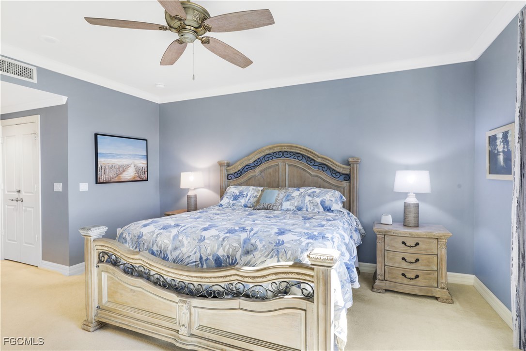 3426 Hancock Bridge Parkway, Unit 704 North Fort Myers, FL 33903 - Photo 15 of 37 a bedroom with a bed and a chandelier