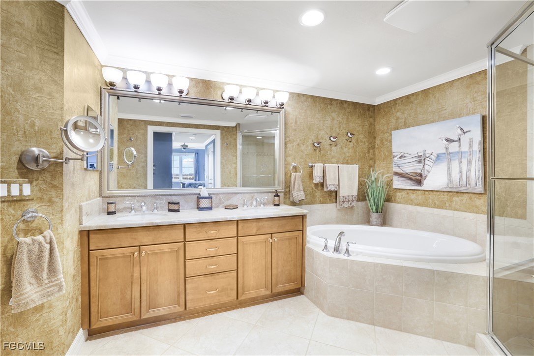 3426 Hancock Bridge Parkway, Unit 704 North Fort Myers, FL 33903 - Photo 16 of 37 a spacious bathroom with a double vanity sink mirror and bathtub