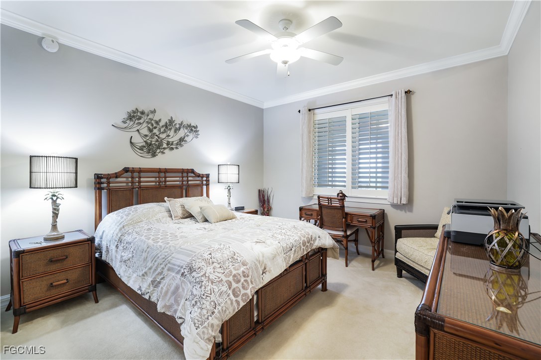 3426 Hancock Bridge Parkway, Unit 704 North Fort Myers, FL 33903 - Photo 19 of 37 a bedroom with a bed and a chandelier