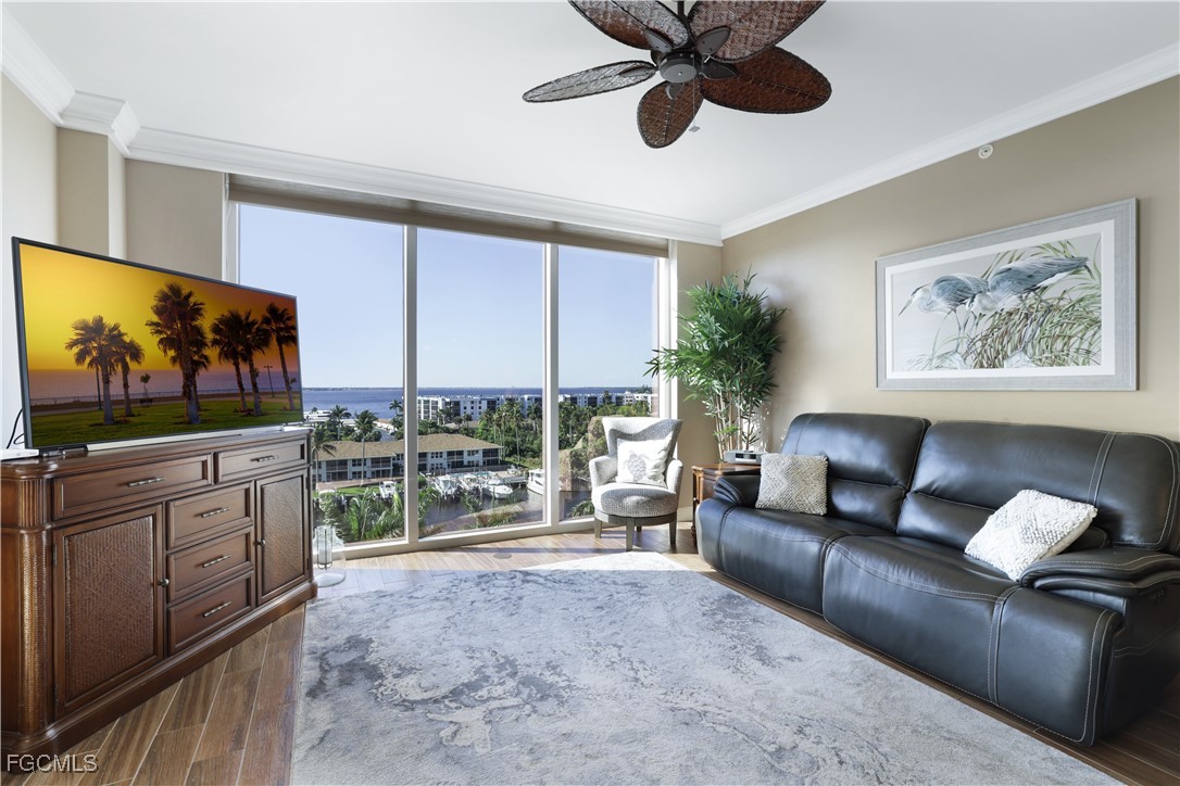 3426 Hancock Bridge Parkway, Unit 704 North Fort Myers, FL 33903 - Photo 6 of 37 a living room with furniture and a flat screen tv