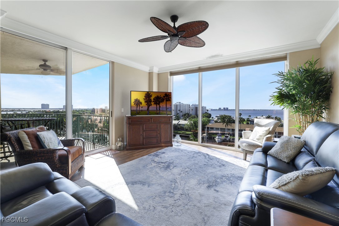 3426 Hancock Bridge Parkway, Unit 704 North Fort Myers, FL 33903 - Photo 7 of 37 a living room with furniture a ceiling fan and a large window