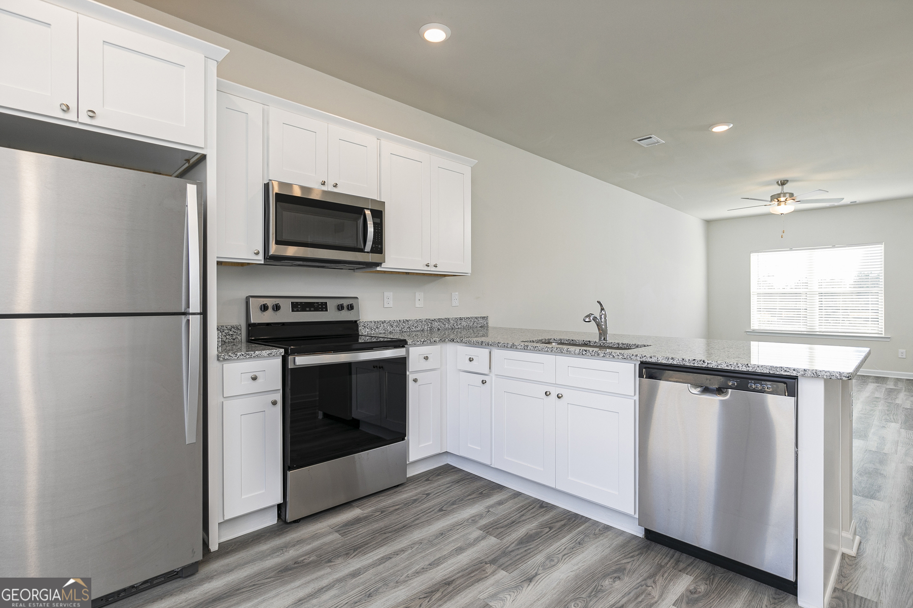 239 Rooker Drive LaGrange, GA 30241 - Photo 3 of 11 a kitchen with granite countertop a refrigerator stove and microwave