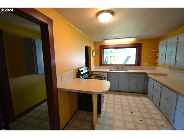 a kitchen with a sink and cabinets