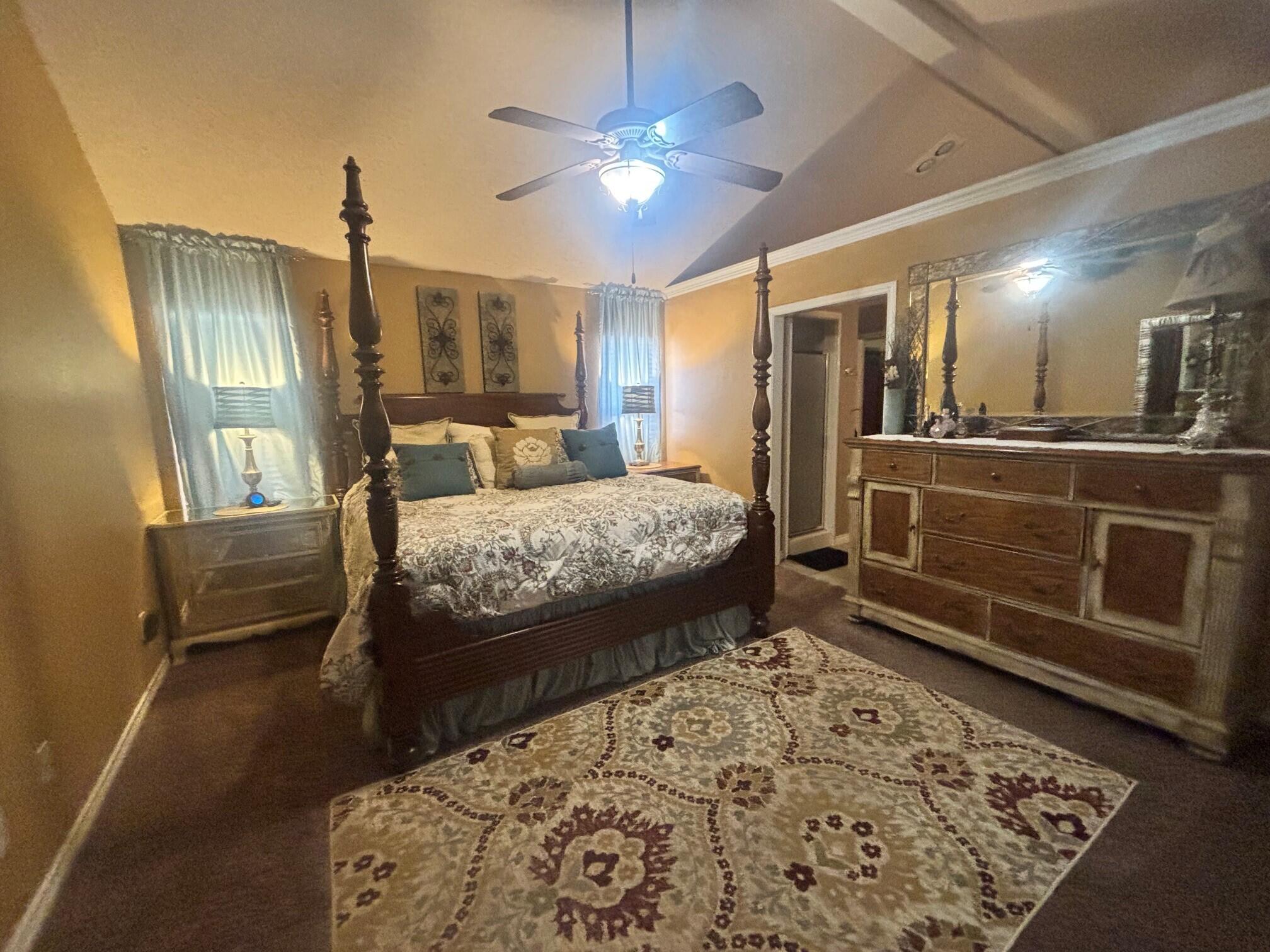 3713 106th Street Lubbock, TX 79423 - Photo 7 of 22 a bedroom with a bed and glass walk in closet