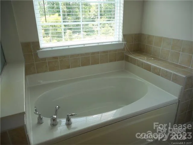 a bath tub sitting next to a window